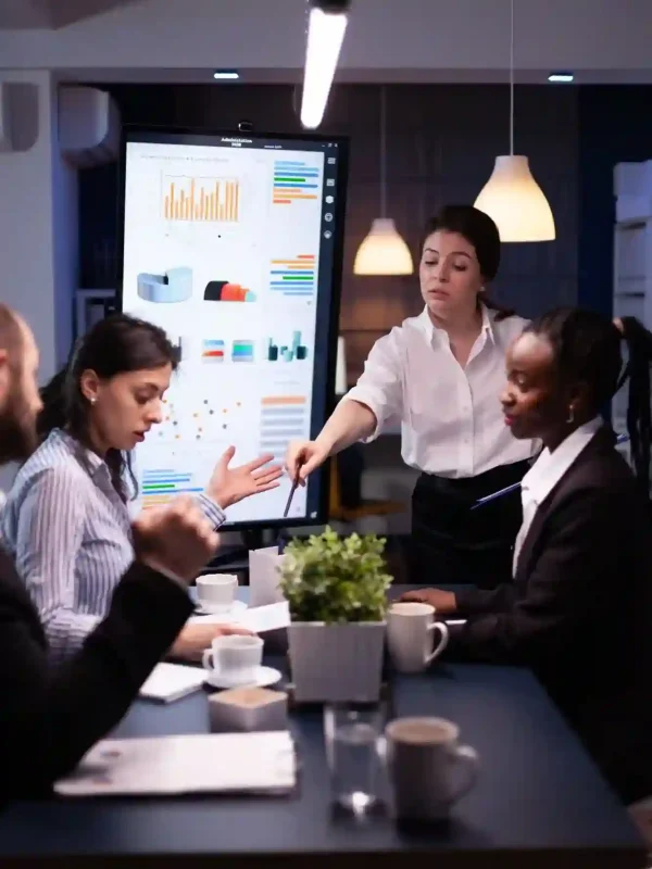 multi-ethnic-businesspeople-discussing-financial-company-solution-sitting-conference-table-meeting-room